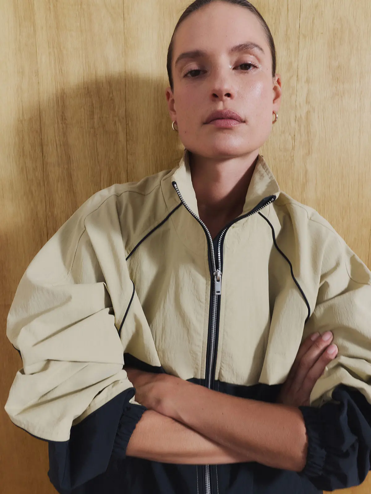 Woman wearing neutral track jacket