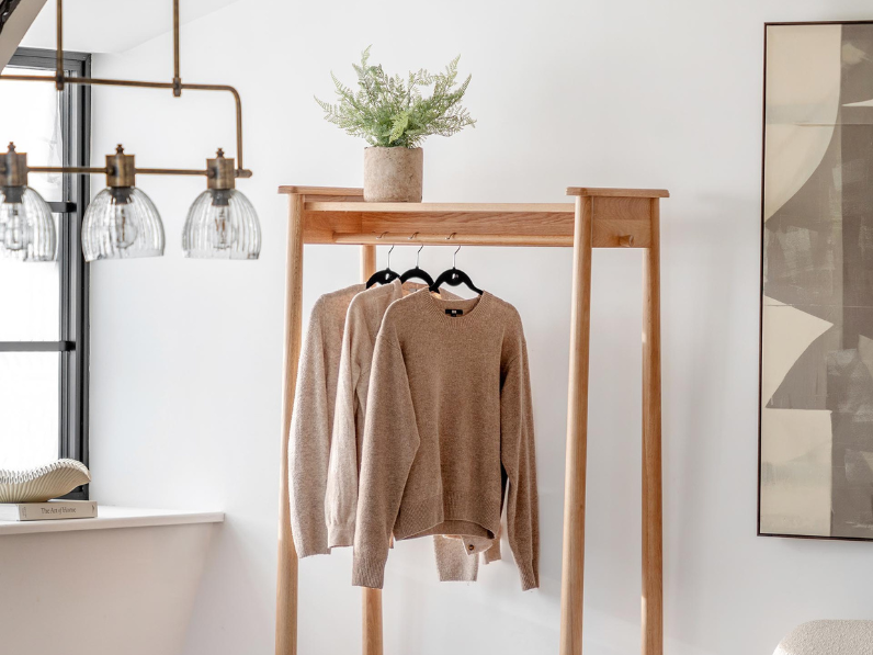 Open wardrobe with knitwear organised inside