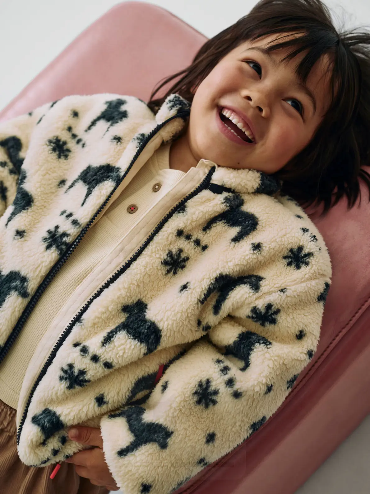 Toddler wearing horse-print borg-textured fleece