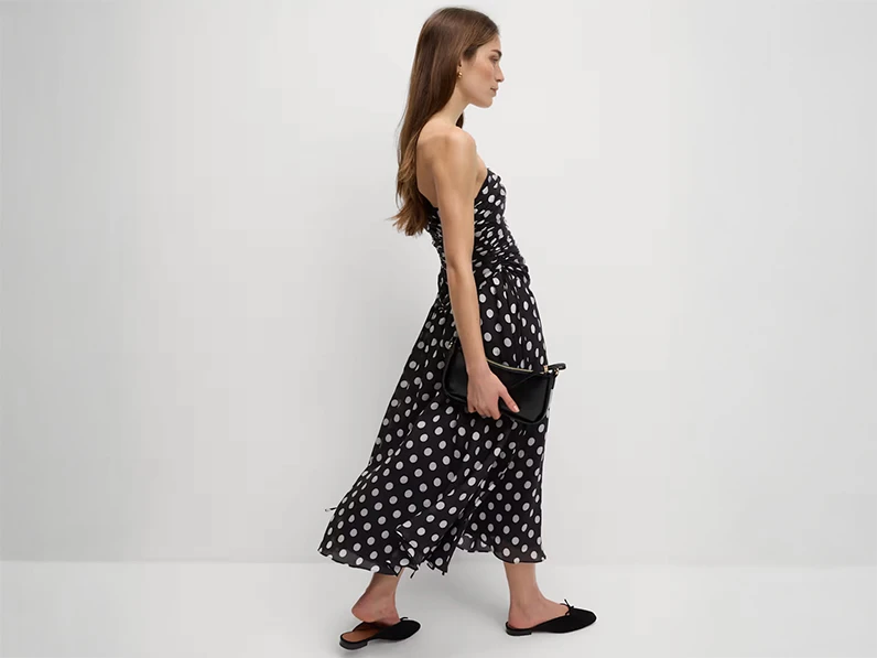 woman wearing black and white polka-dot dress