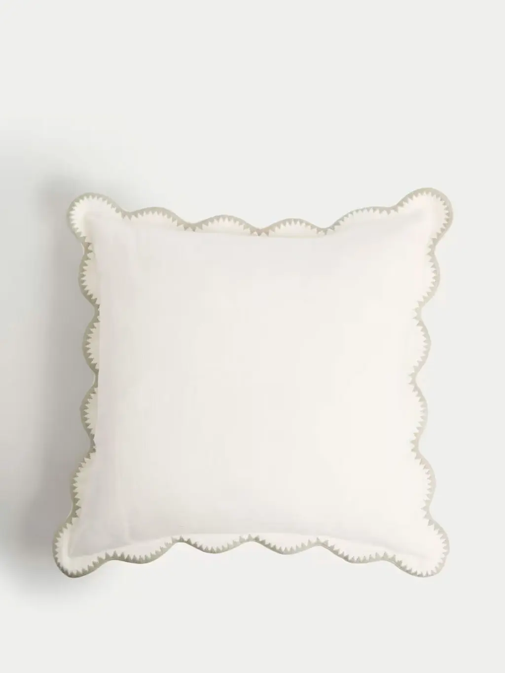 Ecru linen cushion with stitched scalloped edges 
