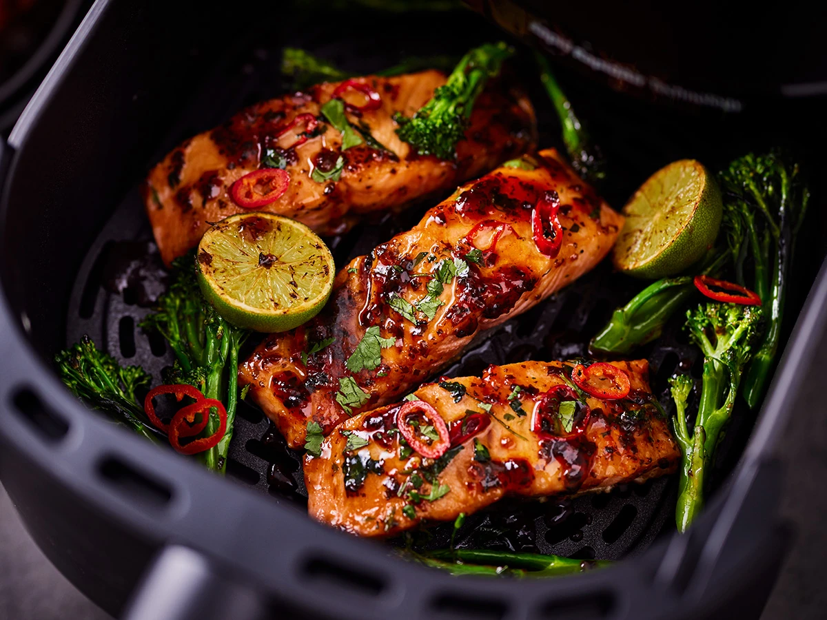 An air fryer with salmon fillets