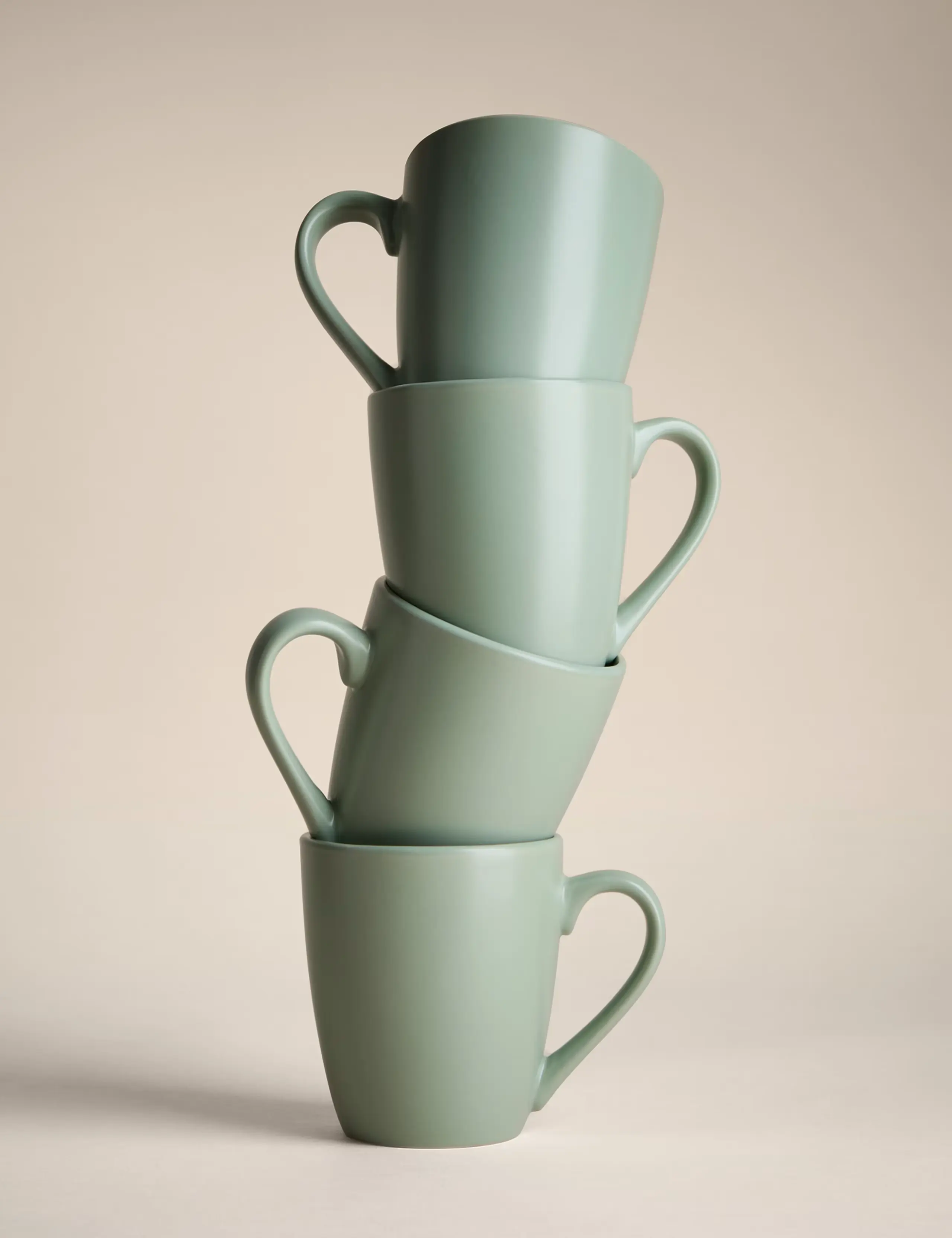 A stack of sage mugs