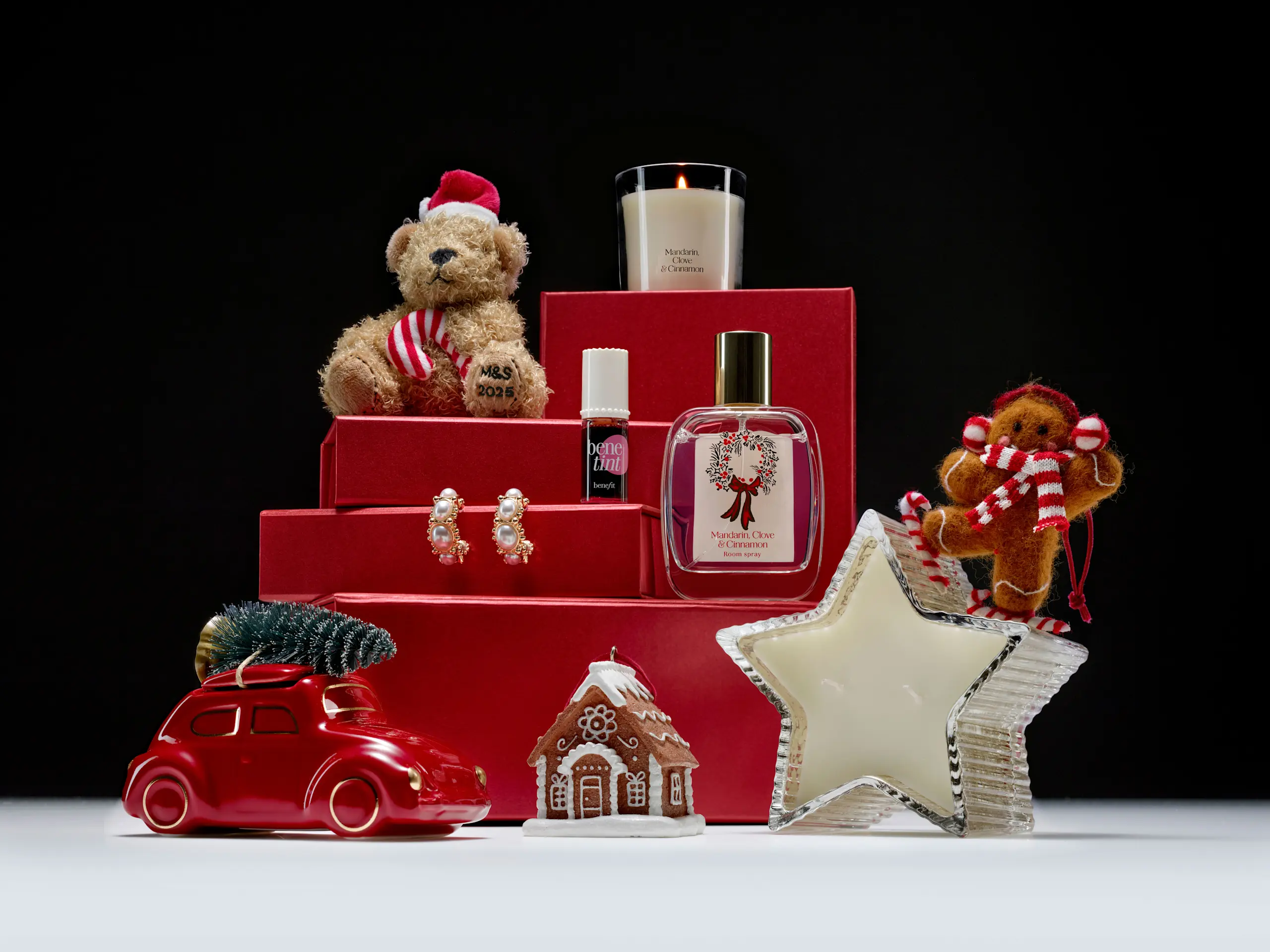Image of gift items including teddy bear, beauty tint, earrings and candle