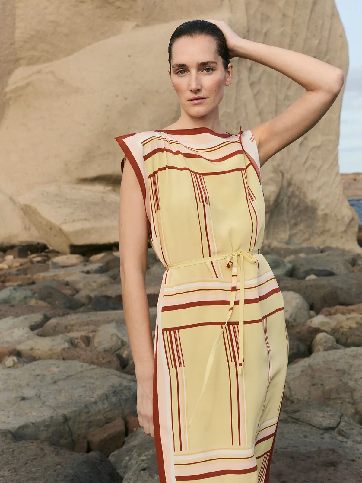 Woman wearing yellow and red patterned dress