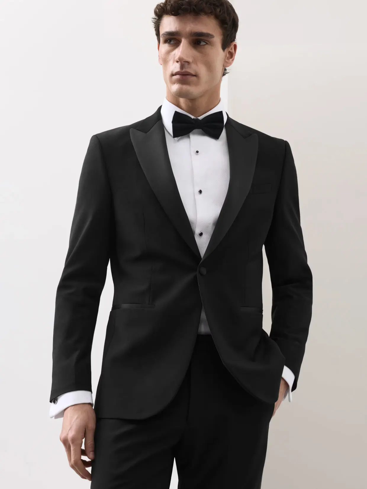 Man wearing suit with bow tie