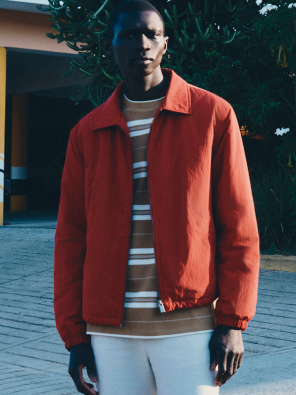 Man wearing jacket over striped T-shirt