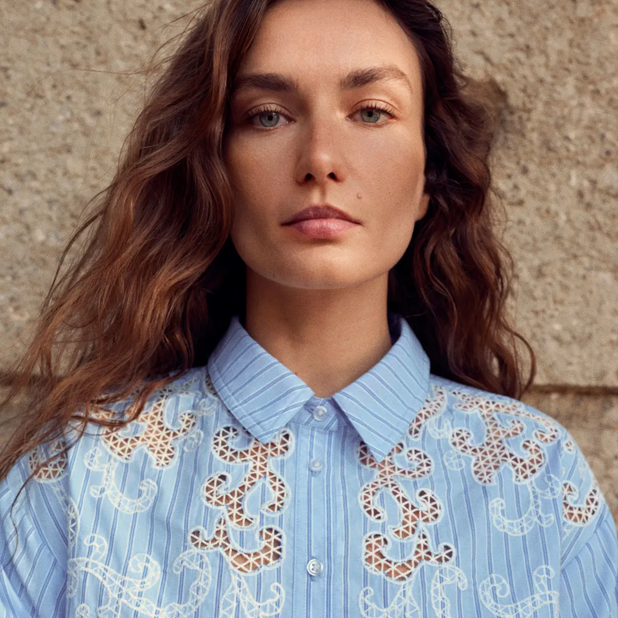 Woman wearing blue embroidered shirt