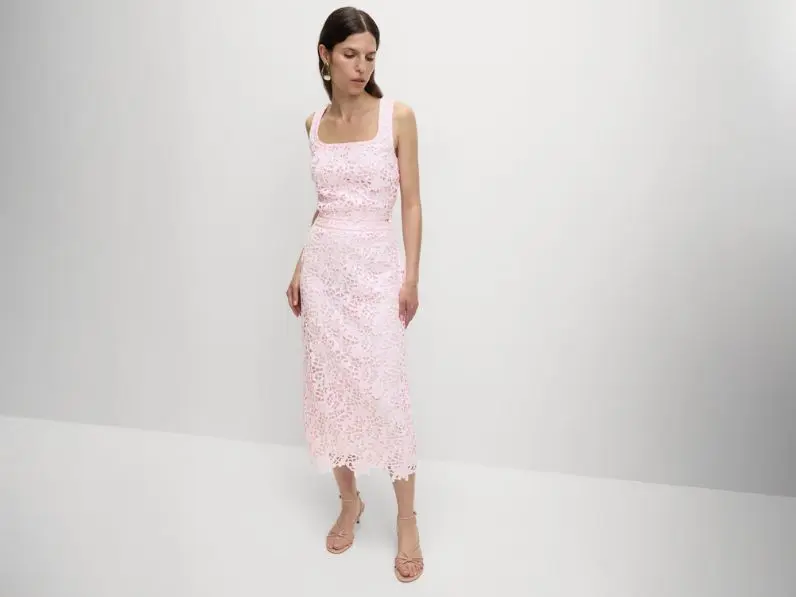 A woman wears a pastel pink co-ord