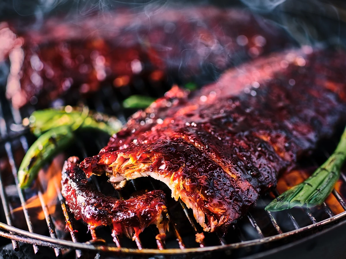Tom Kerridge baby back ribs on a barbecue
