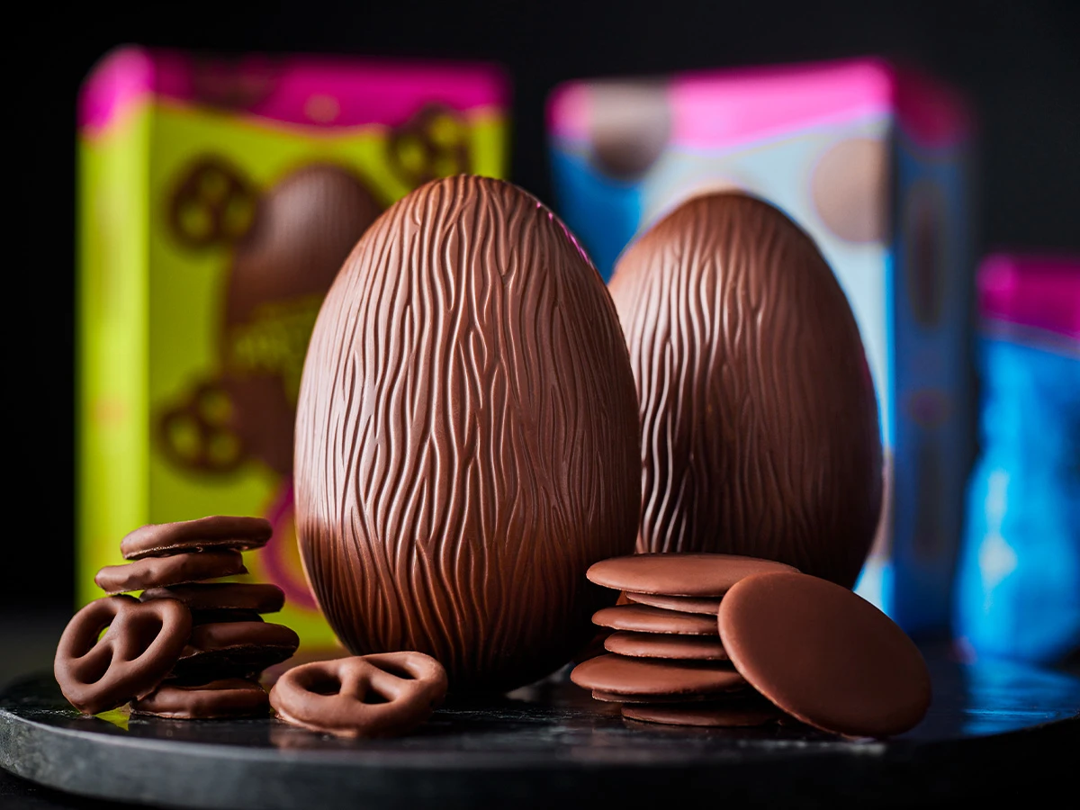 Two Easter eggs with chocolate pretzels and chocolate buttons