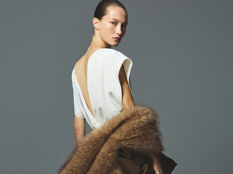 woman wearing white dress with fur scarf
