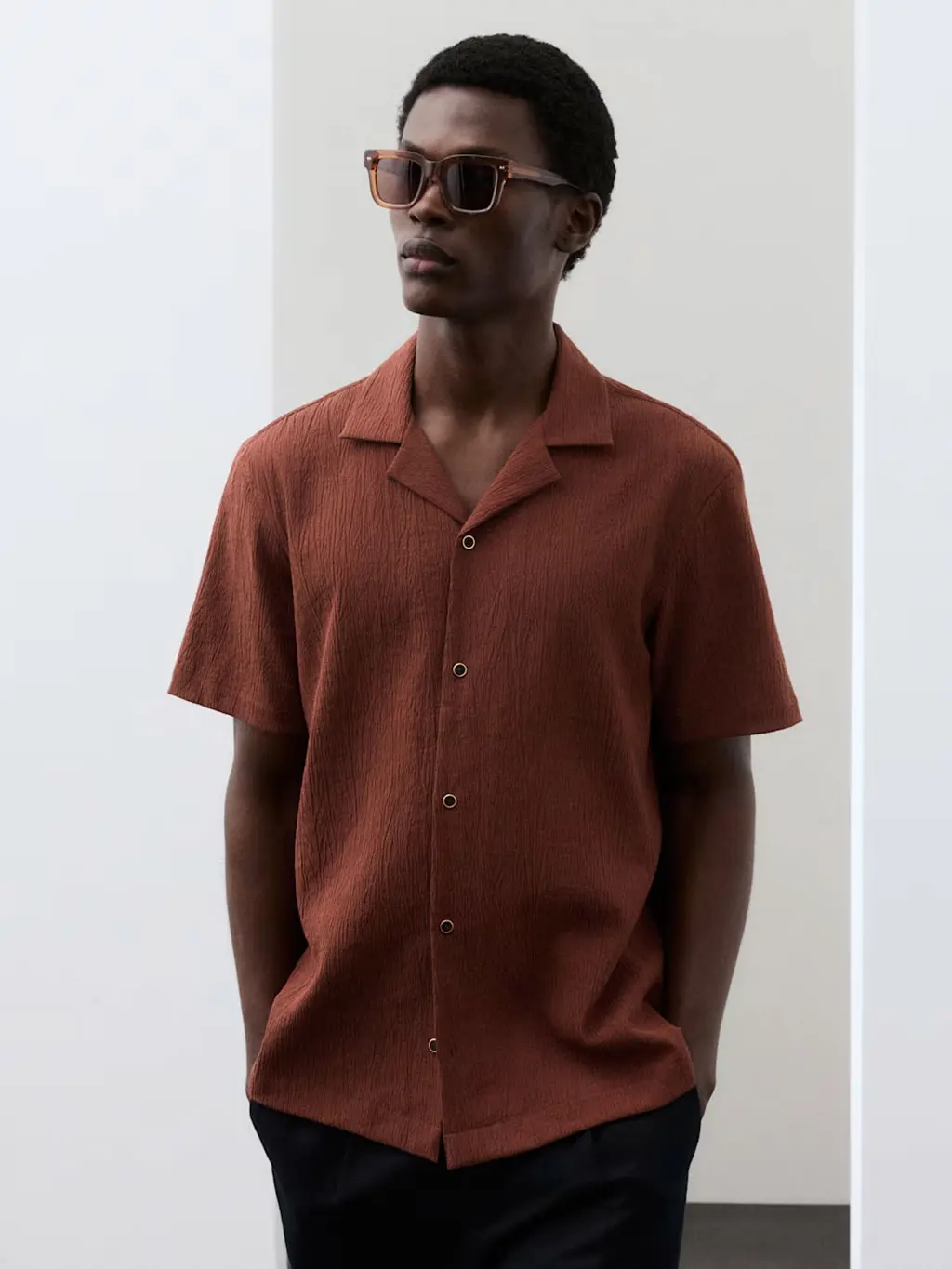 Man wearing a brown polo shirt