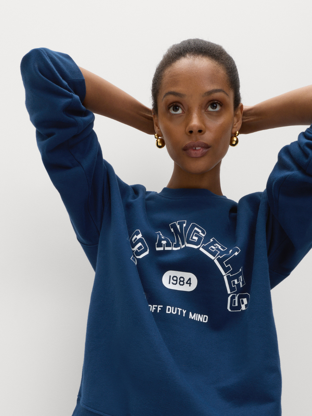 Woman trying on blue sweatshirt
