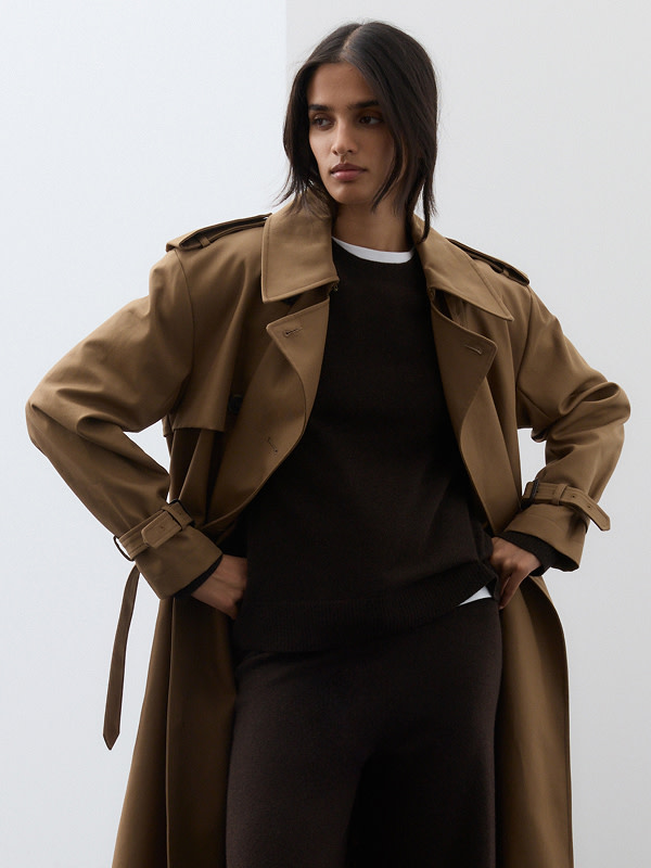Woman in chocolate brown jumper and trench coat