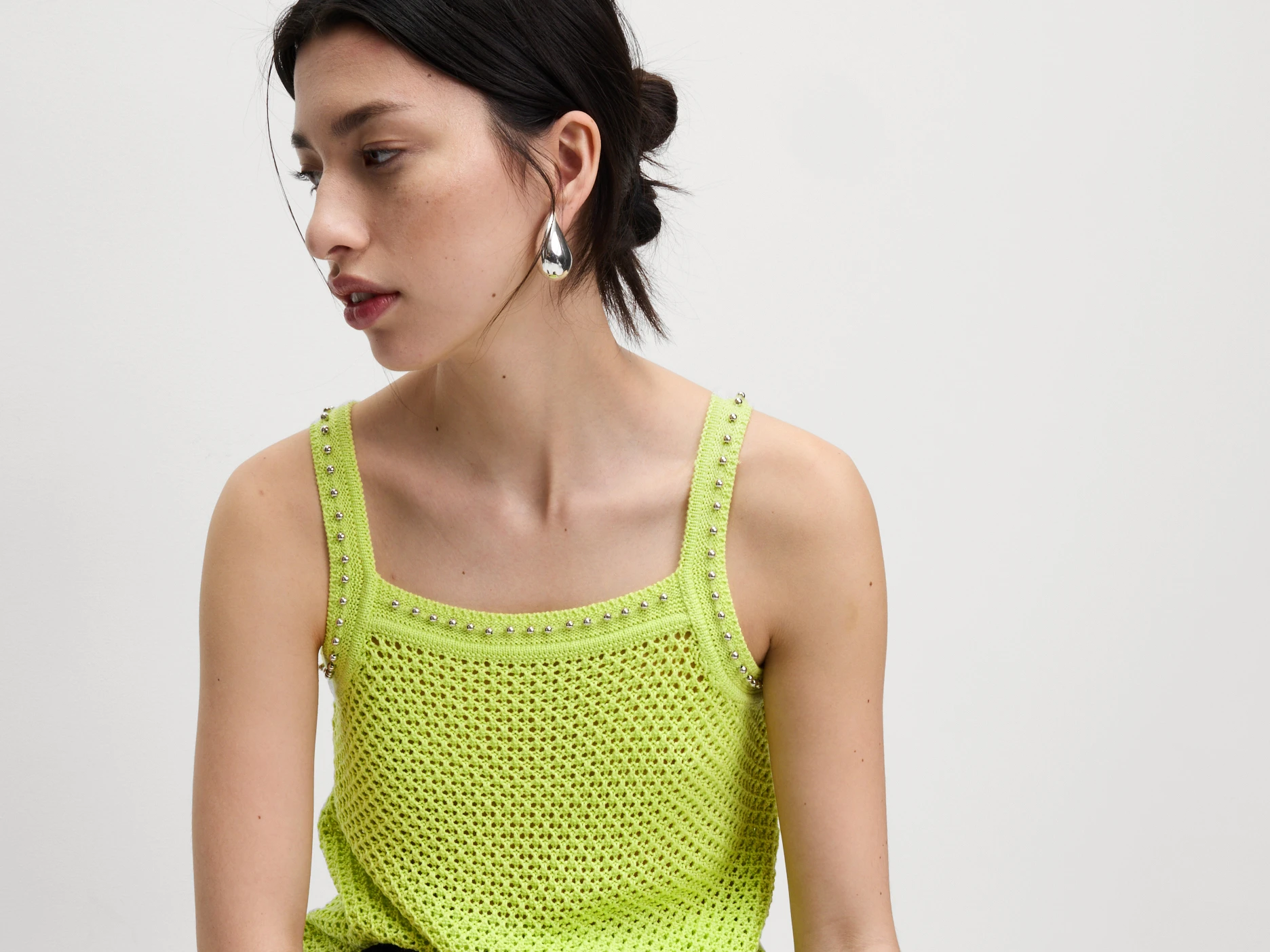 Woman wearing a green knitted top