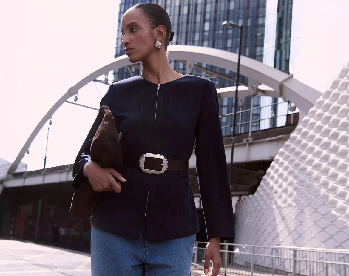 Woman wearing navy blue jacket and jeans