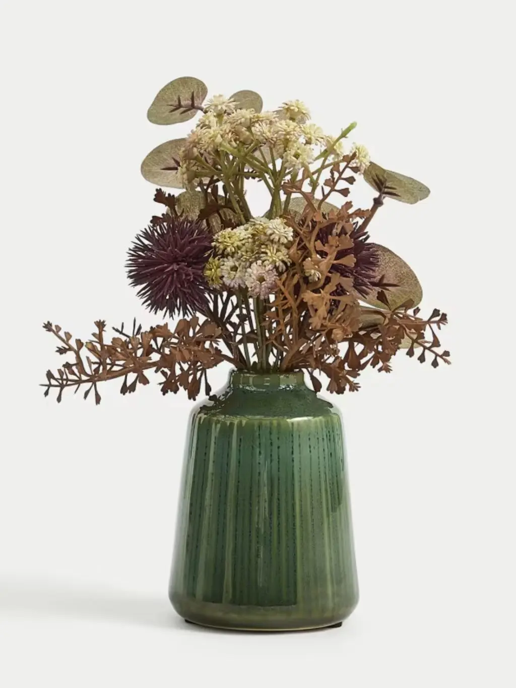 A dried flower arrangement in a green pot