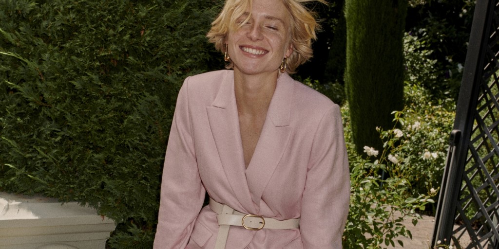 Woman wearing pink suit. Shop occasionwear