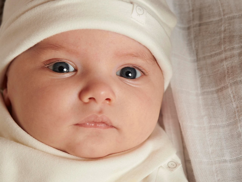 A baby in a newborn baby hat