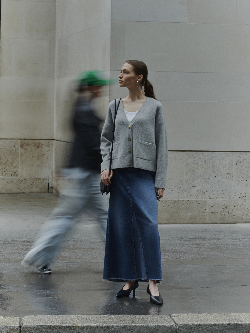 Woman wearing grey cardigan, white T-shirt and blue denim maxi skirt