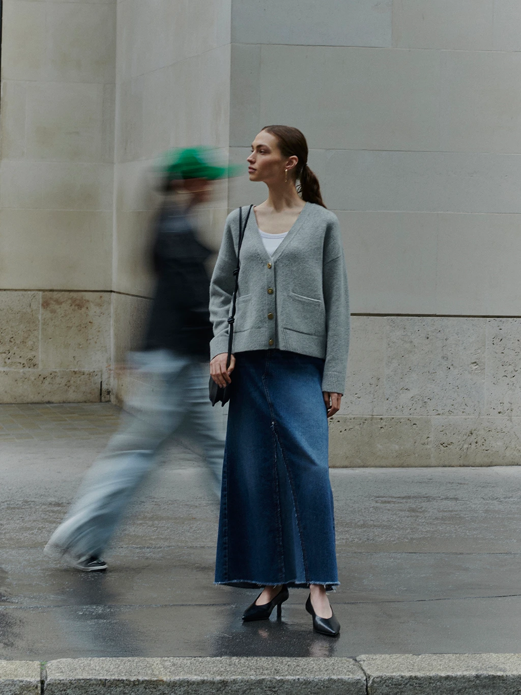 Woman wearing grey cardigan, white T-shirt and blue denim maxi skirt