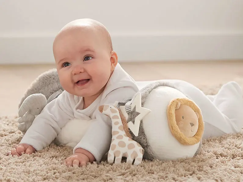 Baby playing with a tummy time roll