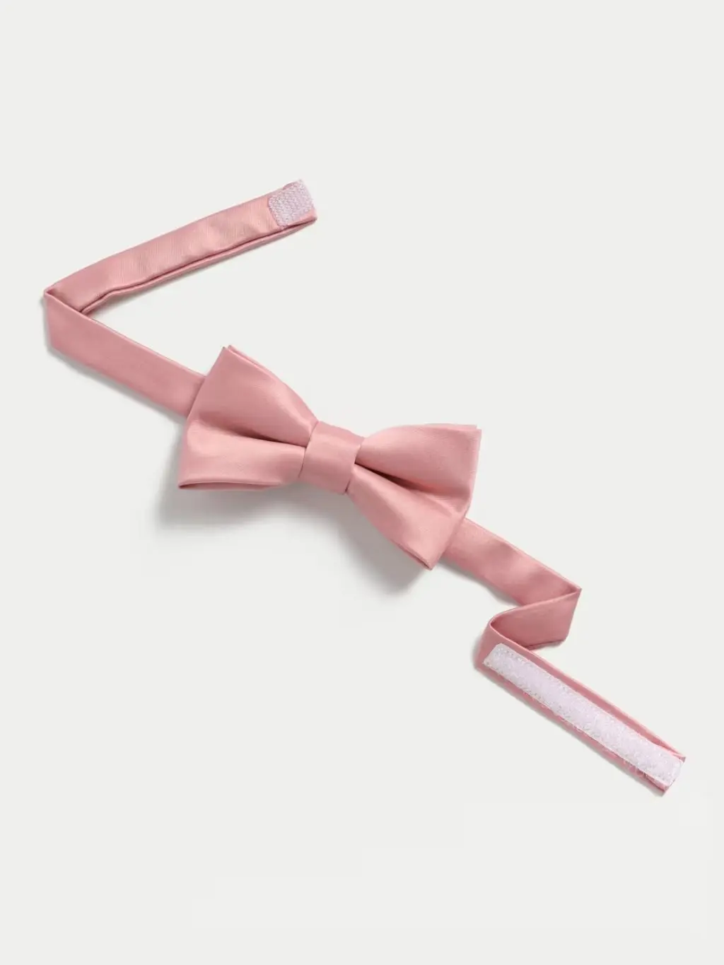 Pink kids' bow tie shot on a pale grey background