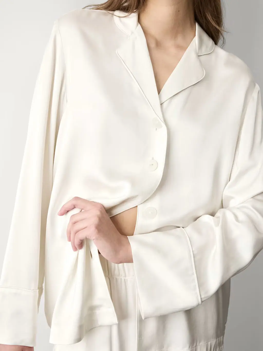 Woman wearing an ivory satin pyjama set