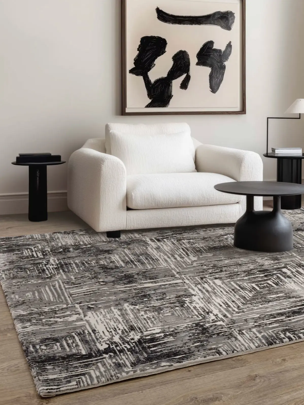 White sofa, dark washed rug and monochrome wall art 