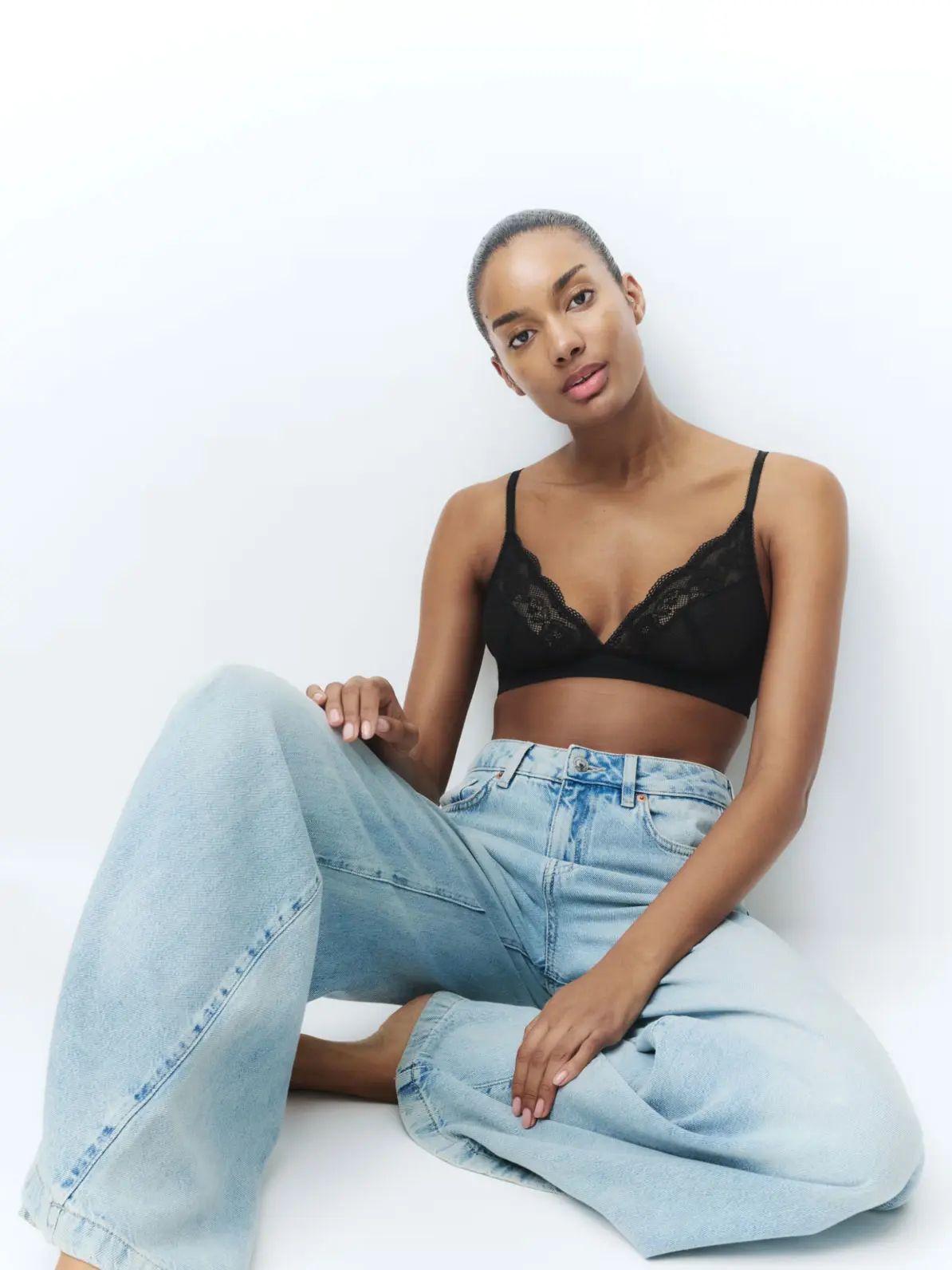 Woman wearing jeans and black bra 