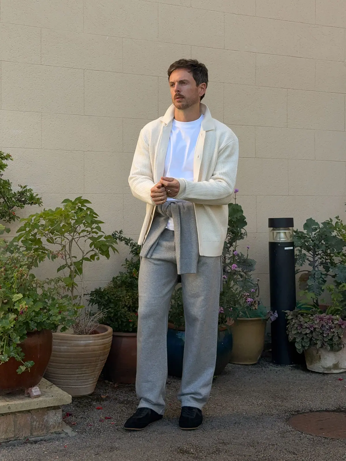 Influencer Nick Howard-Lanes wearing a cream cardigan with a white T-shirt and grey joggers