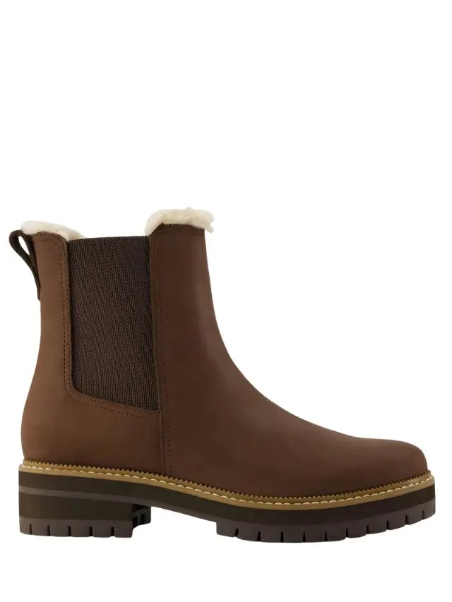 A brown leather Chelsea ankle boot with fur lining by Toms at M&S