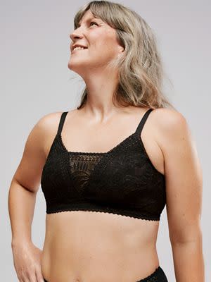 Woman wearing black lace post-surgery bra. Book a post-surgery bra fit
