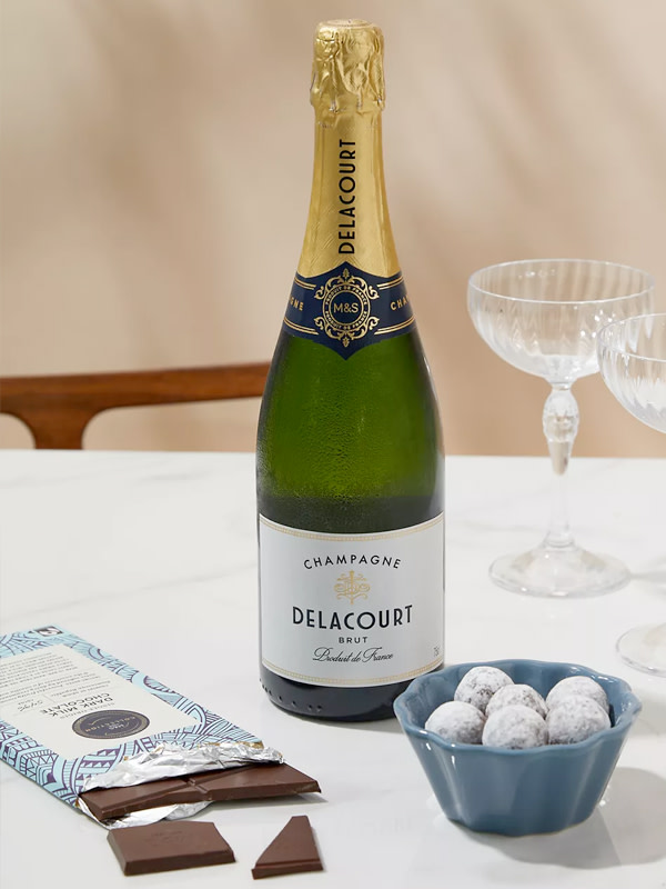 
Delacourt champagne bottle with truffles and two champagne glasses. Shop anniversary gifts