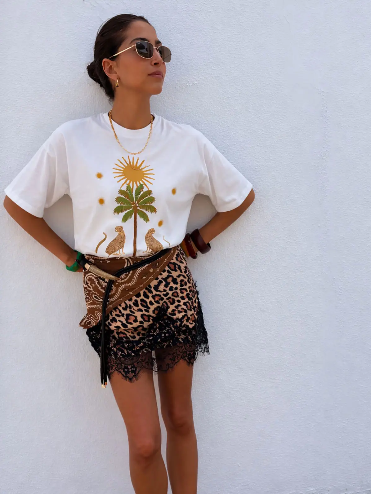 Woman wearing graphic T-shirt and leopard-print mini skirt 