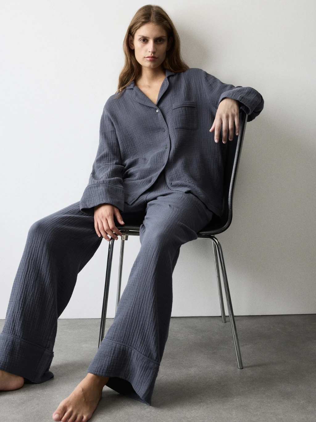 Woman wearing dark blue cotton muslin pyjamas