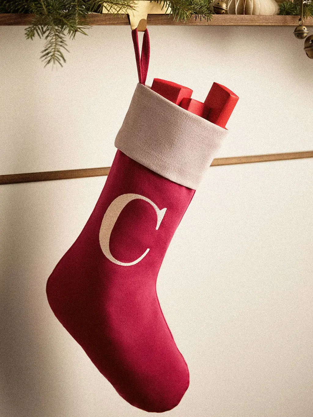 Red stocking embroidered with the initial 'C'.