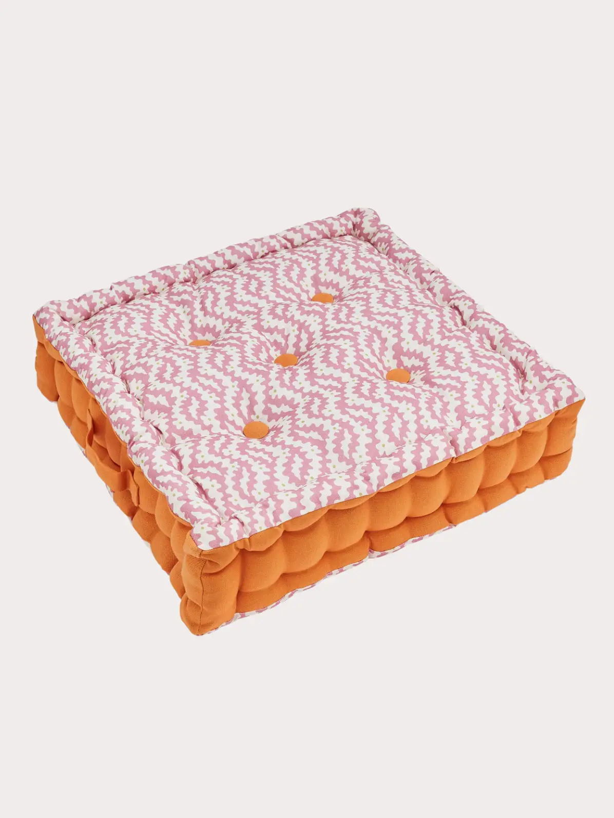 Patterned outdoor cushion in pink and orange 