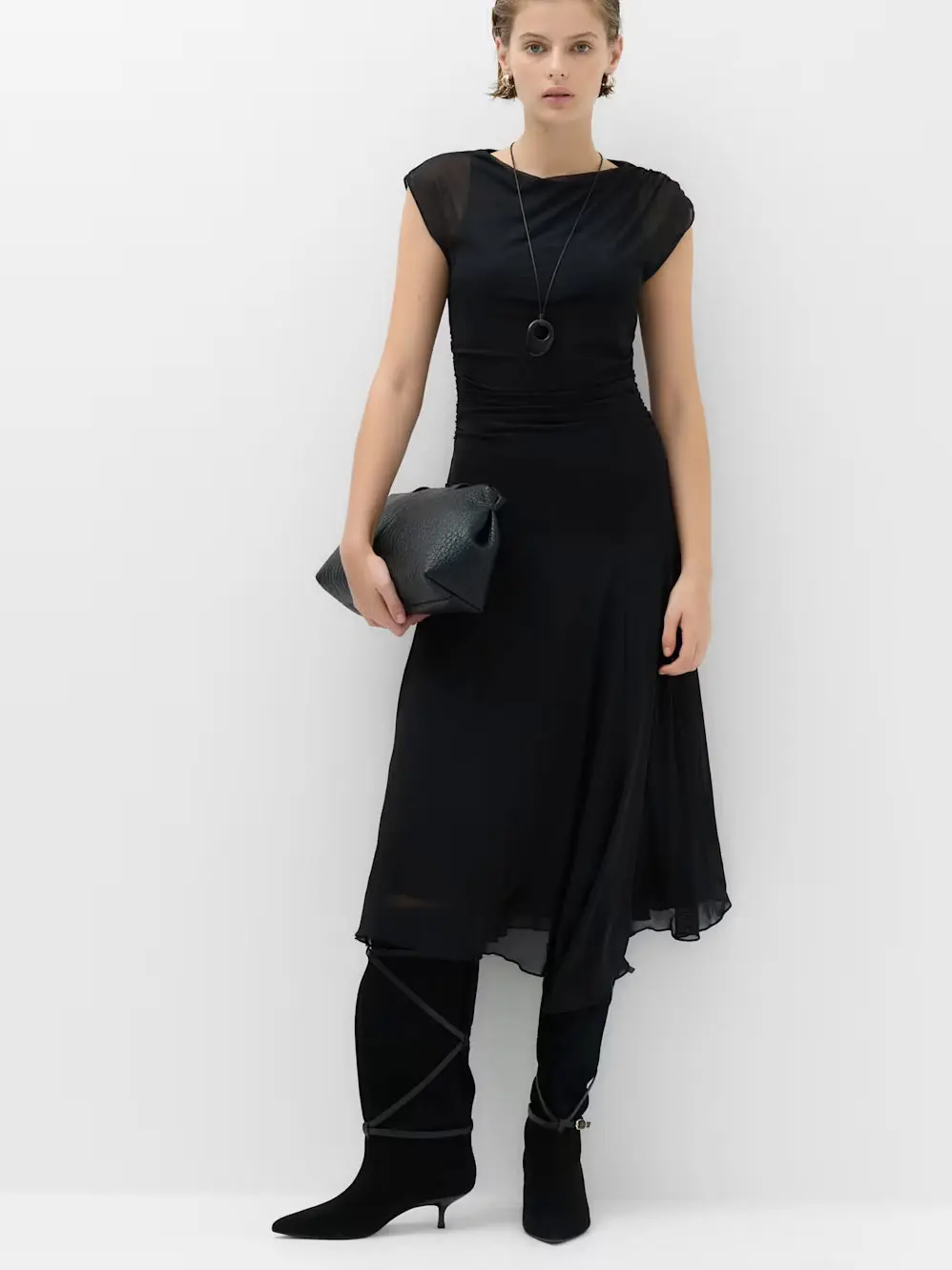 Woman in black dress and boots