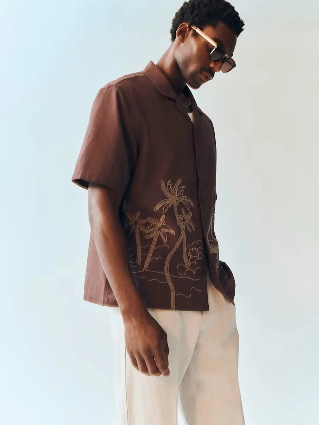 Man wearing a brown embroidered shirt