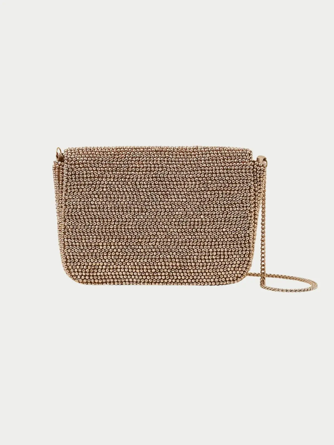 A cut out of a gold beaded clutch bag shot against a pale background