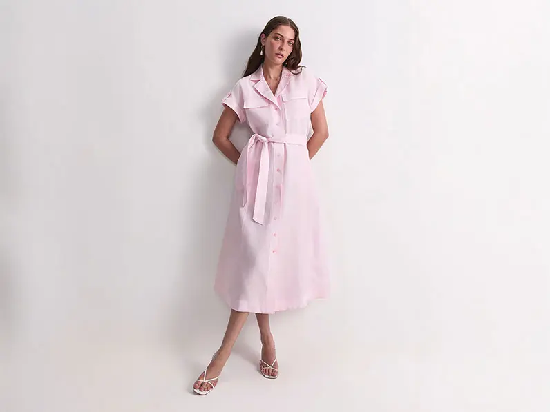 Woman wearing a pink shirt dress with cream heels