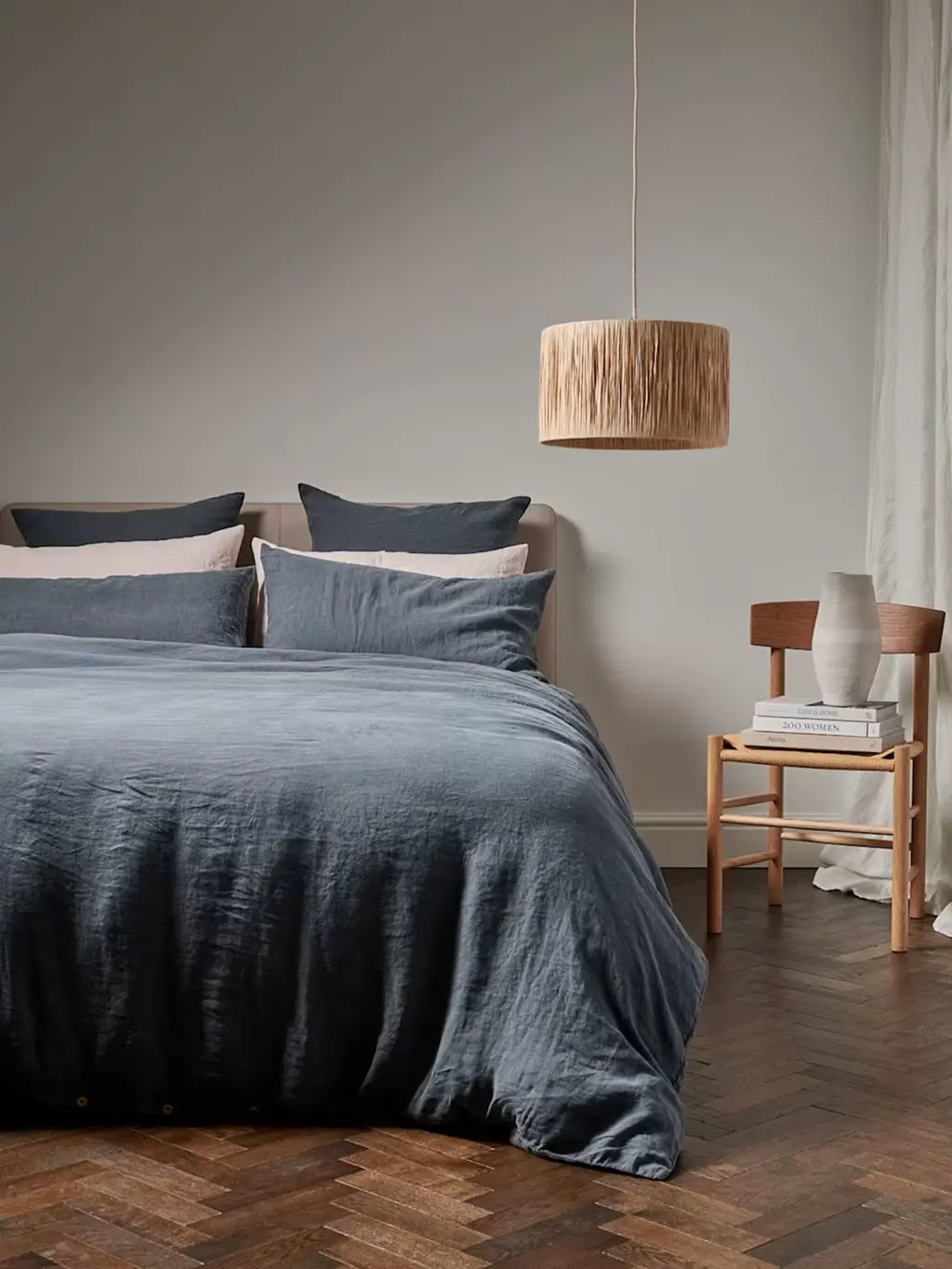 Bed dressed with grey and pink bedding