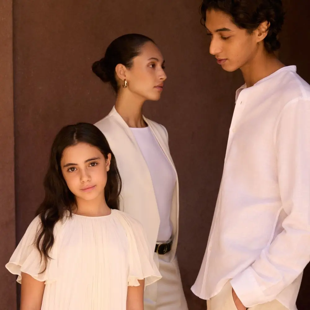 A family dressed in smart white clothing