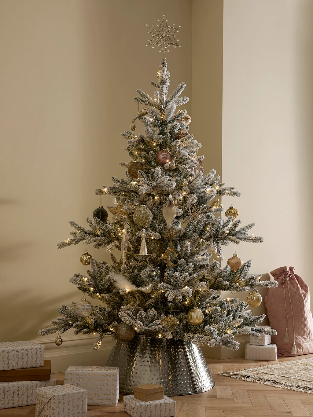 Snowy Christmas tree with gold and silver decorations