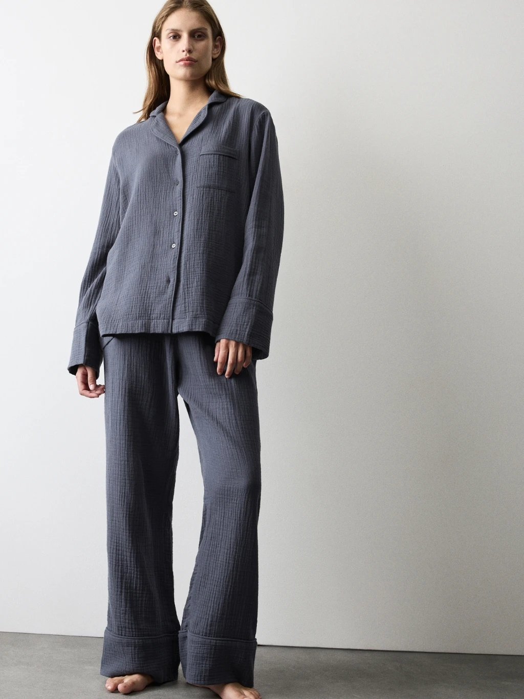 Woman wearing dark blue muslin pyjamas