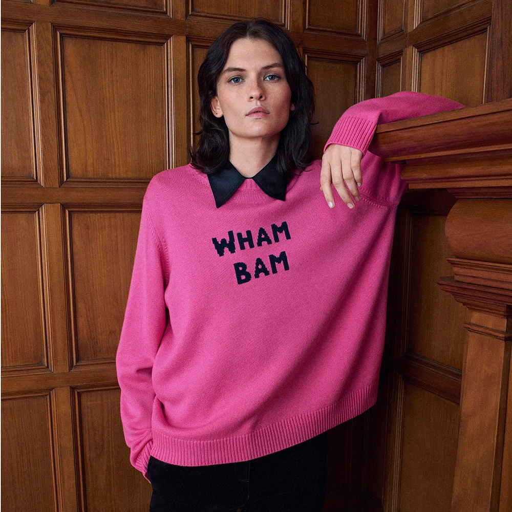 Woman wearing pink 'Wham Bam' jumper and black shirt by M&S x Bella Freud