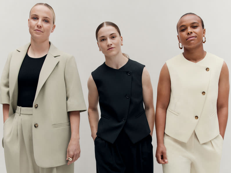 Three England women's football team players wearing the M&S x England collection