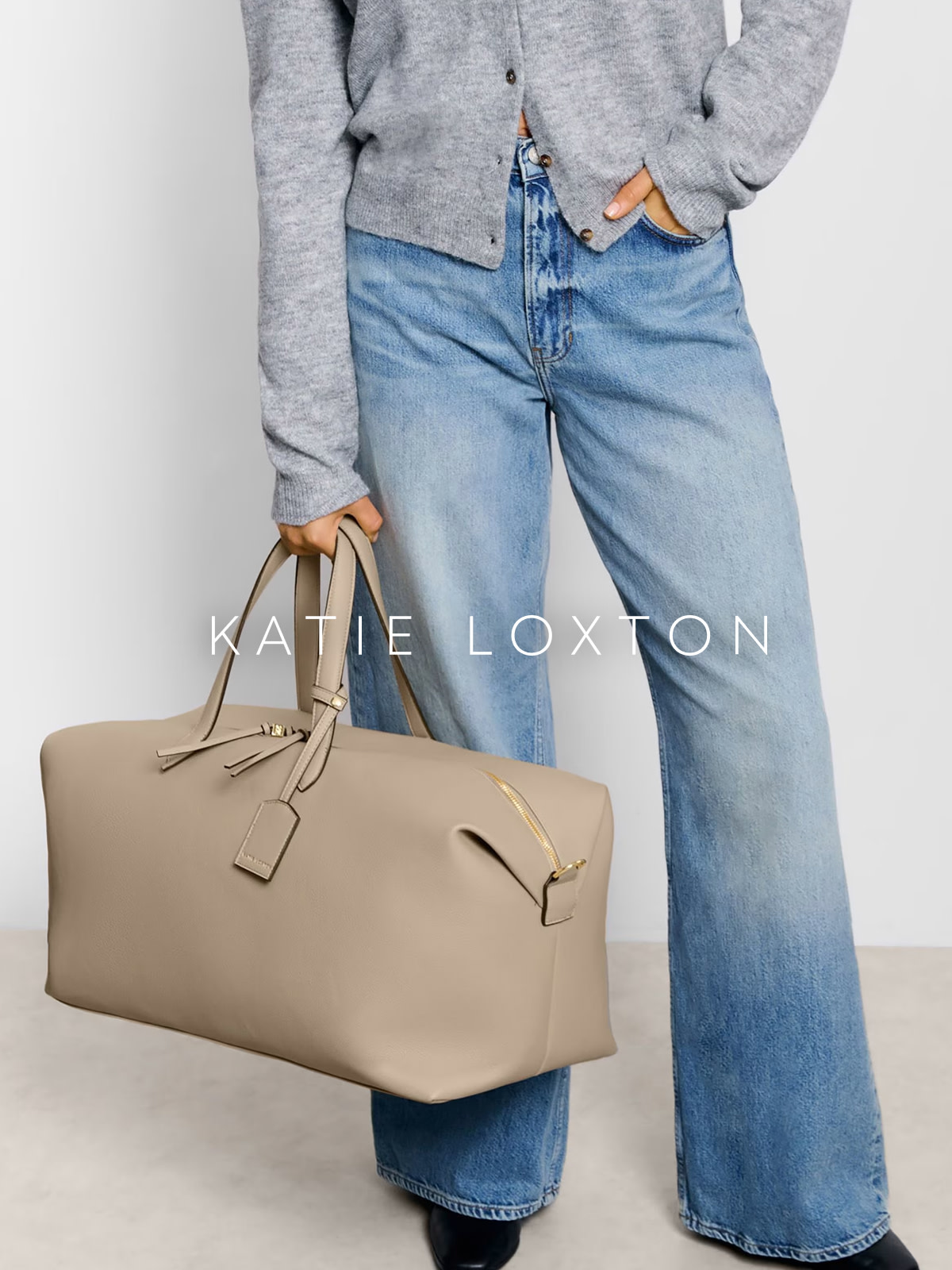 Woman holding Katie Loxton overnight bag